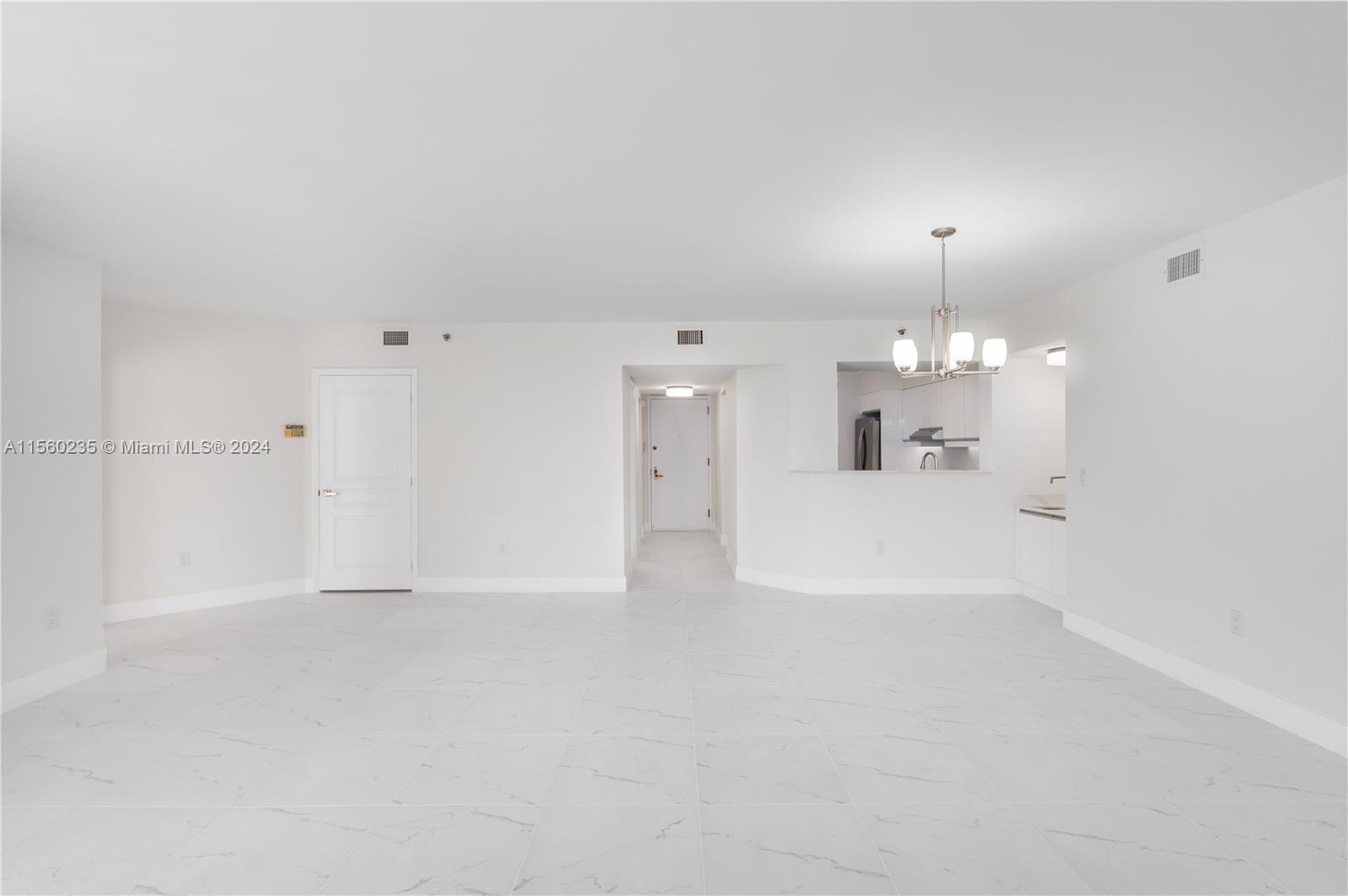 8925 Collins Avenue, Unit 2J Surfside, FL 33154 - Photo 57 of 62 a view of a big room with wooden floor and kitchen