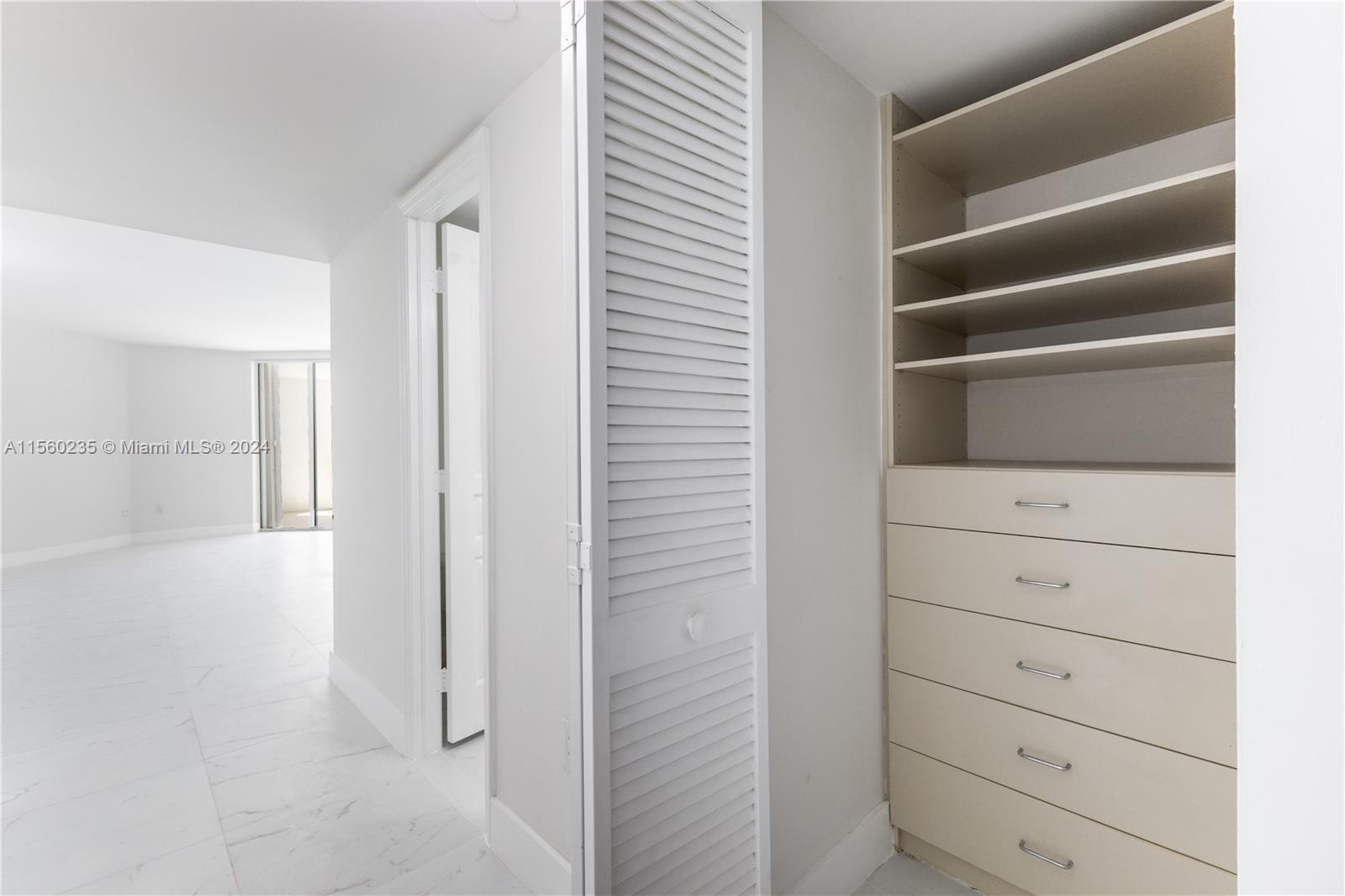 8925 Collins Avenue, Unit 2J Surfside, FL 33154 - Photo 58 of 62 a view of walk in closet with empty racks