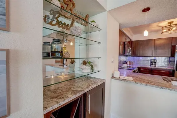 a kitchen with stainless steel appliances granite countertop a sink and a refrigerator