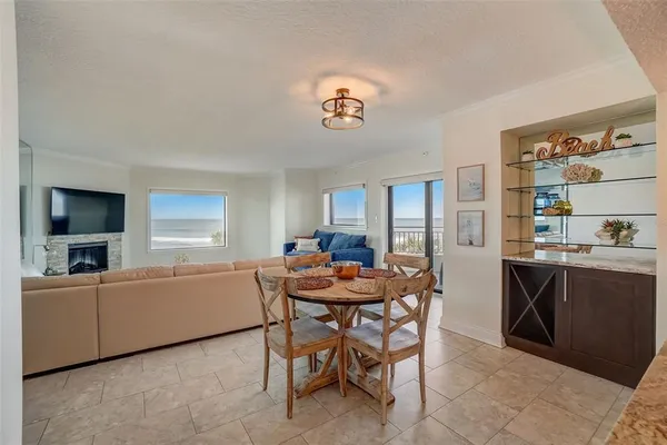 a view of a dining room with furniture and a kitchen