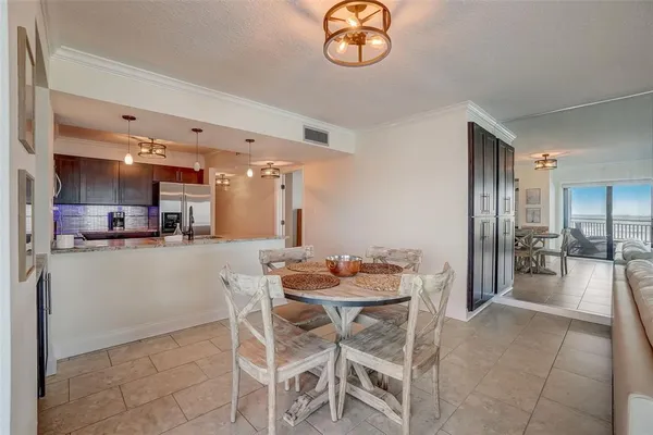 a kitchen with a refrigerator and a table