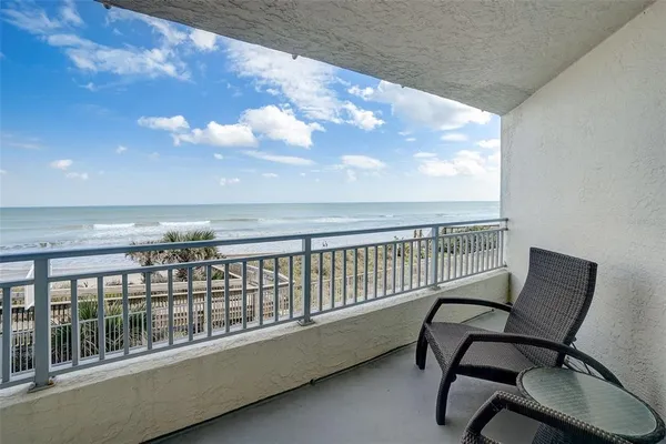 a view of a balcony with wooden floor and outdoor space