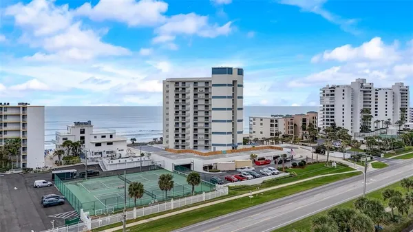 a view of a street with tall buildings and a sign board
