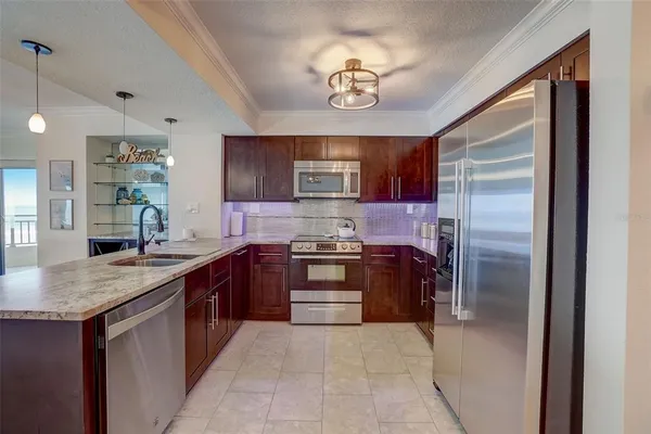 a kitchen with stainless steel appliances granite countertop a refrigerator and a sink