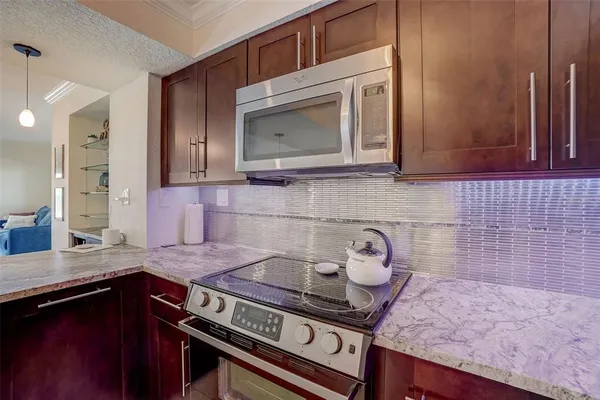 a kitchen with a stove and cabinets