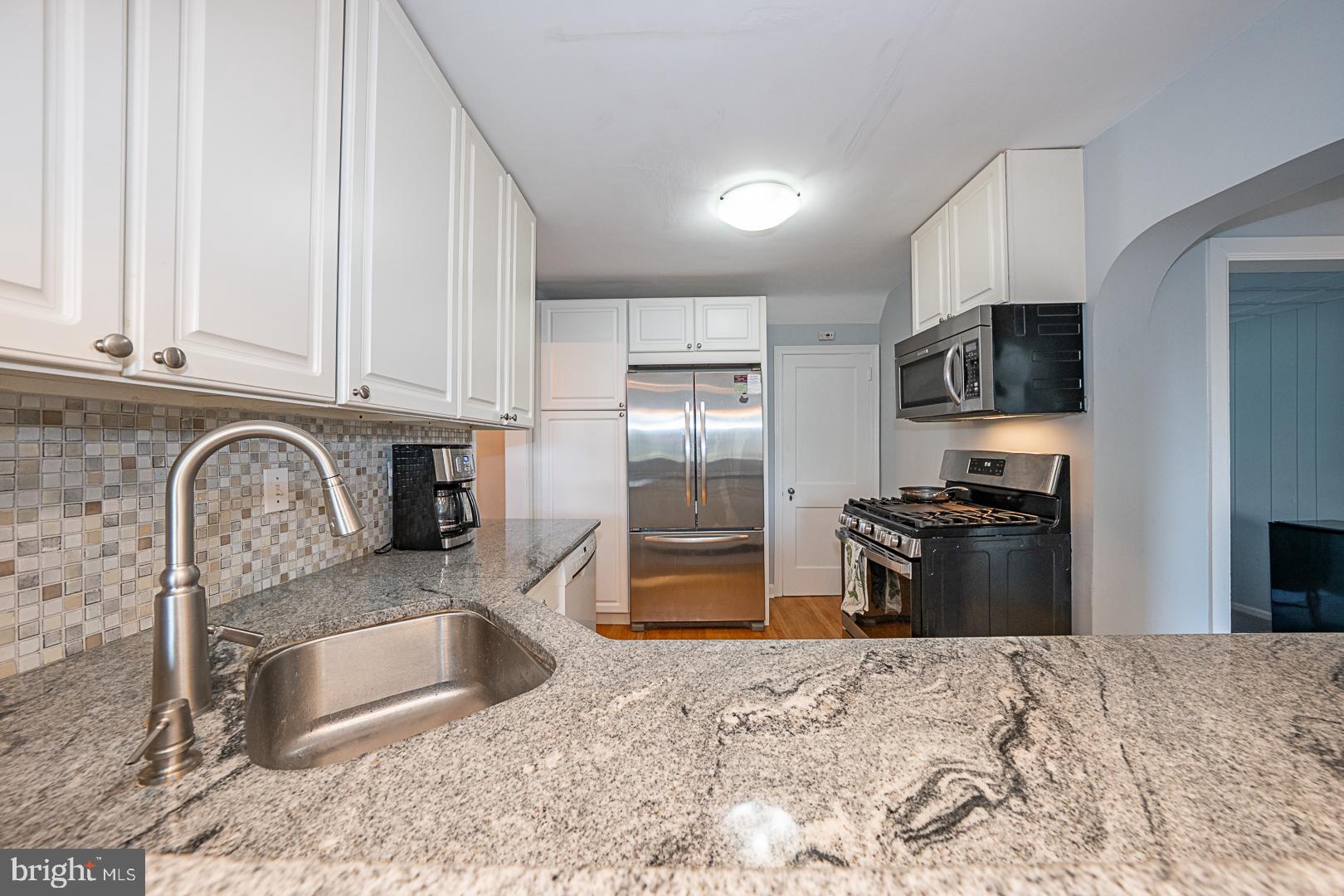 33 Rittenhouse Road Broomall, PA 19008 - Photo 14 of 47 a kitchen with granite countertop a refrigerator and a sink