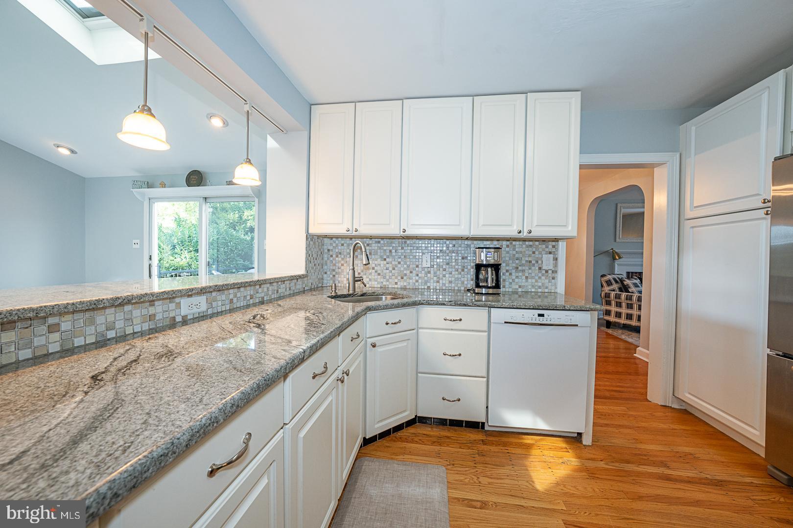 33 Rittenhouse Road Broomall, PA 19008 - Photo 18 of 47 a kitchen with granite countertop white cabinets white appliances a sink and a window