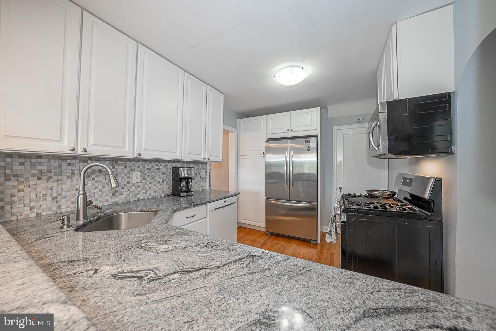 33 Rittenhouse Road Broomall, PA 19008 - Photo 20 of 47 a kitchen with granite countertop a refrigerator stove and sink