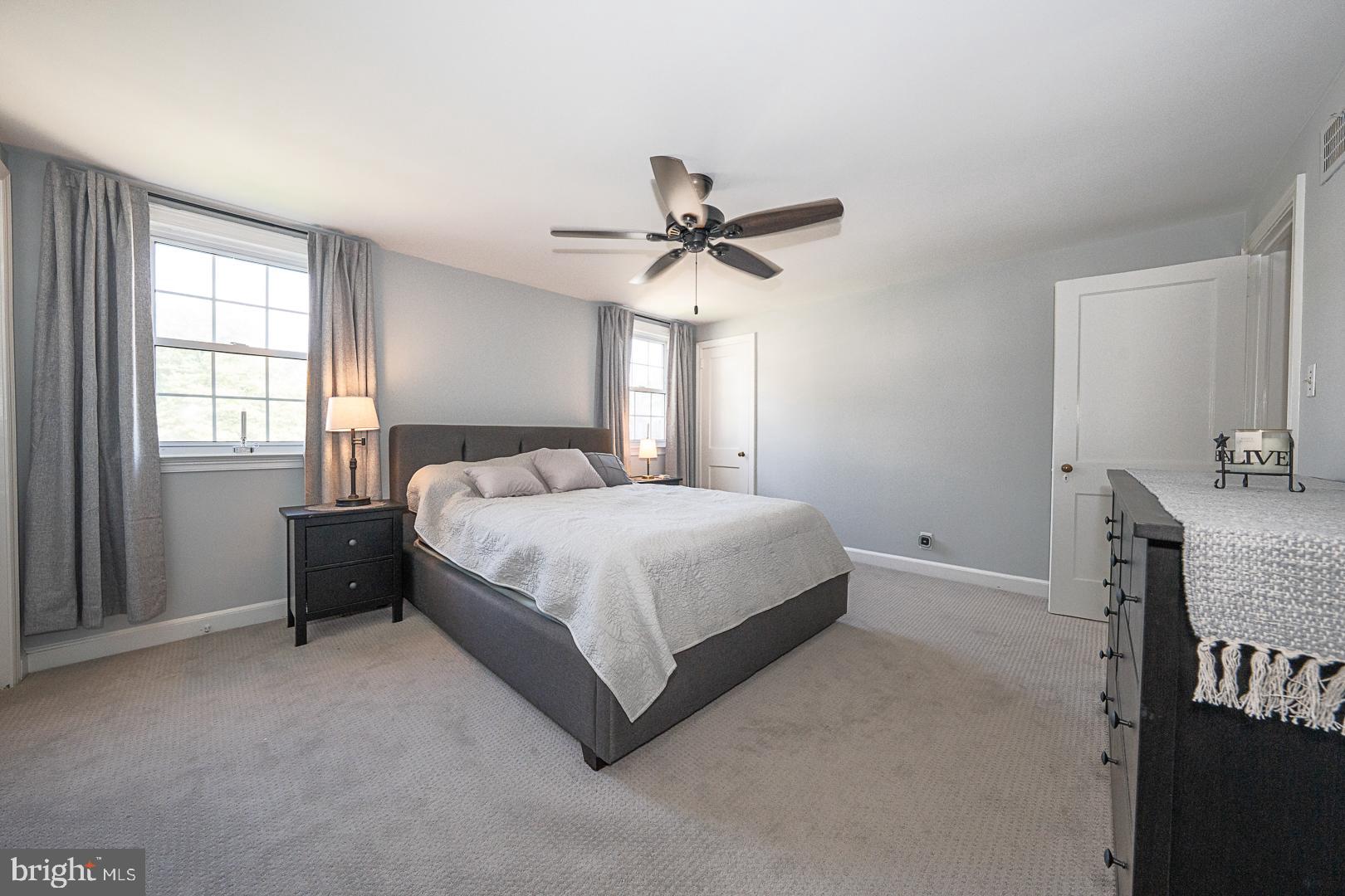 33 Rittenhouse Road Broomall, PA 19008 - Photo 27 of 47 a spacious bedroom with a bed and a chandelier