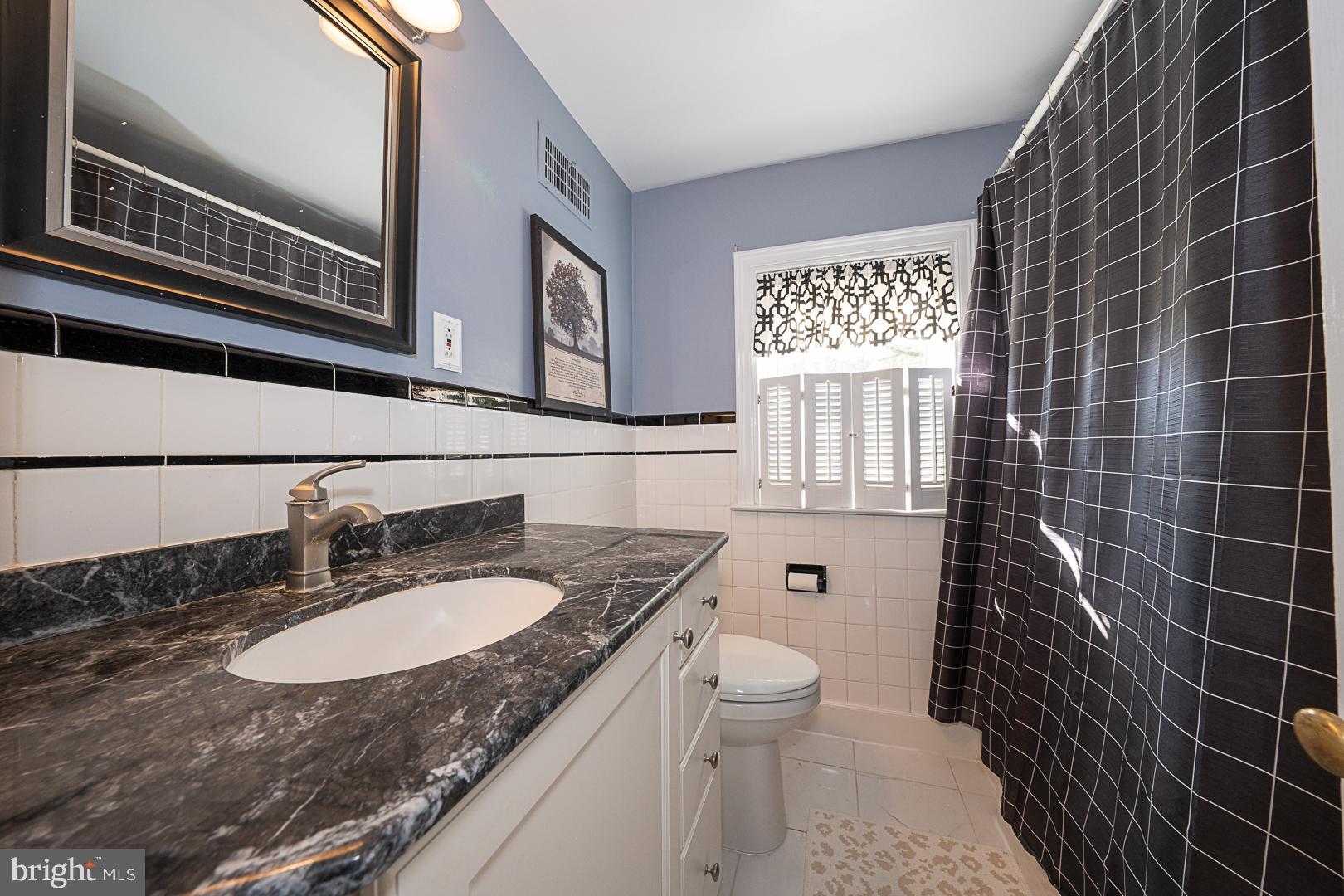 33 Rittenhouse Road Broomall, PA 19008 - Photo 33 of 47 a bathroom with a granite countertop sink toilet a mirror and shower