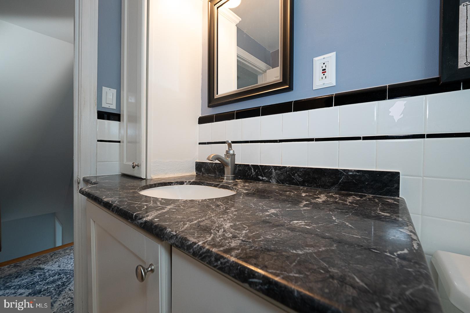 33 Rittenhouse Road Broomall, PA 19008 - Photo 34 of 47 a bathroom with a granite countertop sink and a mirror