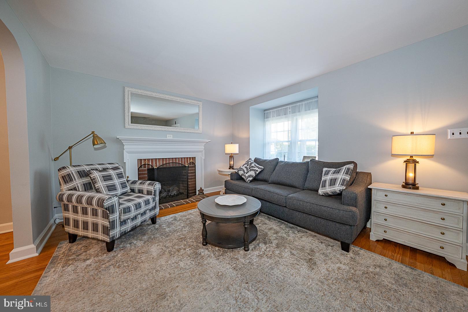 33 Rittenhouse Road Broomall, PA 19008 - Photo 5 of 47 a living room with furniture a fireplace and a lamp