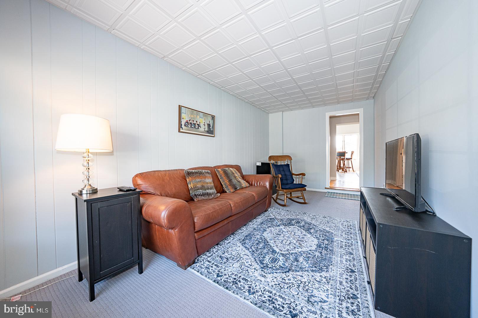 33 Rittenhouse Road Broomall, PA 19008 - Photo 10 of 47 a living room with furniture a flat screen tv and a lamp