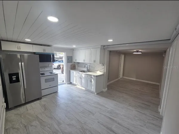 a kitchen with a refrigerator and a sink