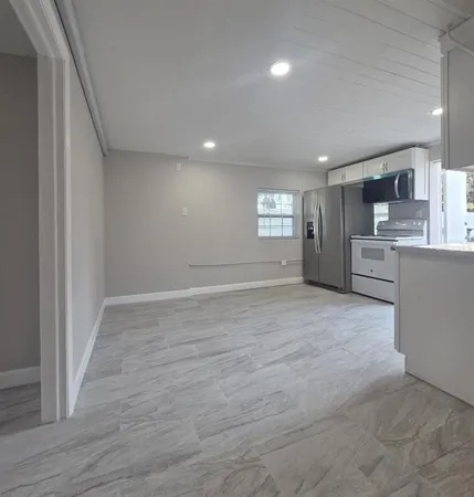 a view of a kitchen and a sink cabinet windows and cabinet