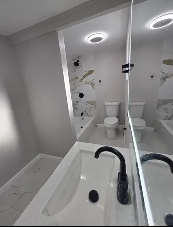 a bathroom with a sink toilet and shower