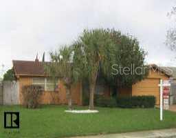 8653 Sabal Way Port Richey, FL 34668 - Photo 1 of 3 a backyard of a house with lots of green space and plants
