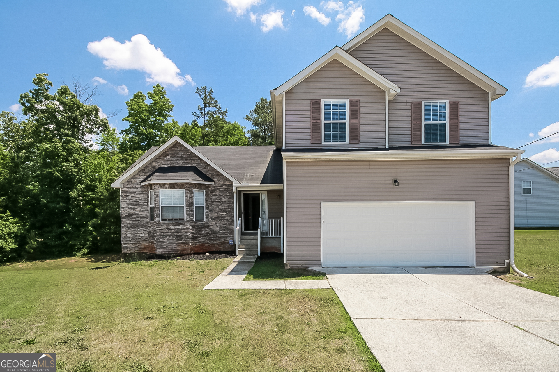 a front view of a house with yard