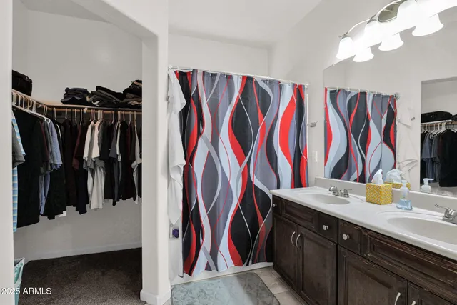 a view of walk in closet with clothes