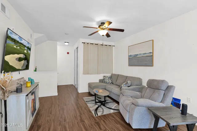 a living room with furniture and wooden floor