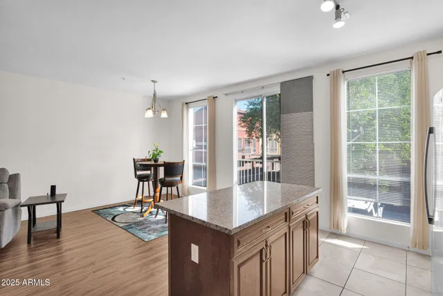 a dining hall with stainless steel appliances granite countertop a granite counter tops and a view of kitchen