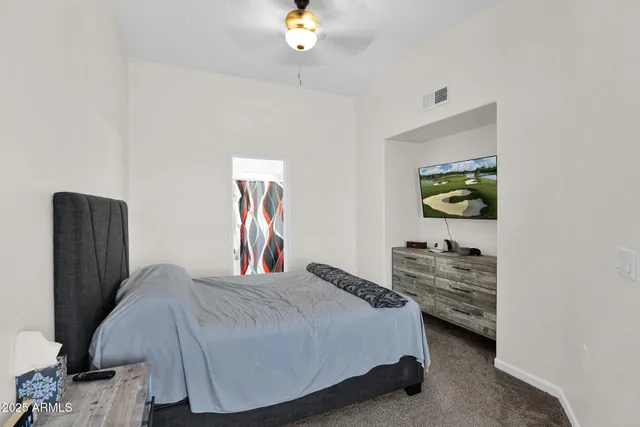 a bedroom with a bed and dresser