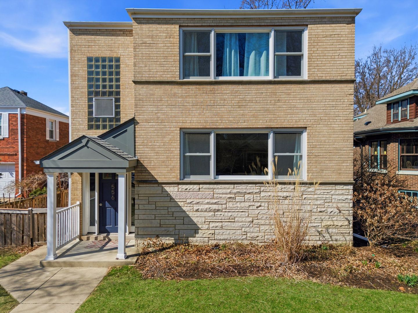 556 Barton Avenue, Unit 2 Evanston, IL 60202 - Photo 1 of 21 a brick house with a small yard and a large windows