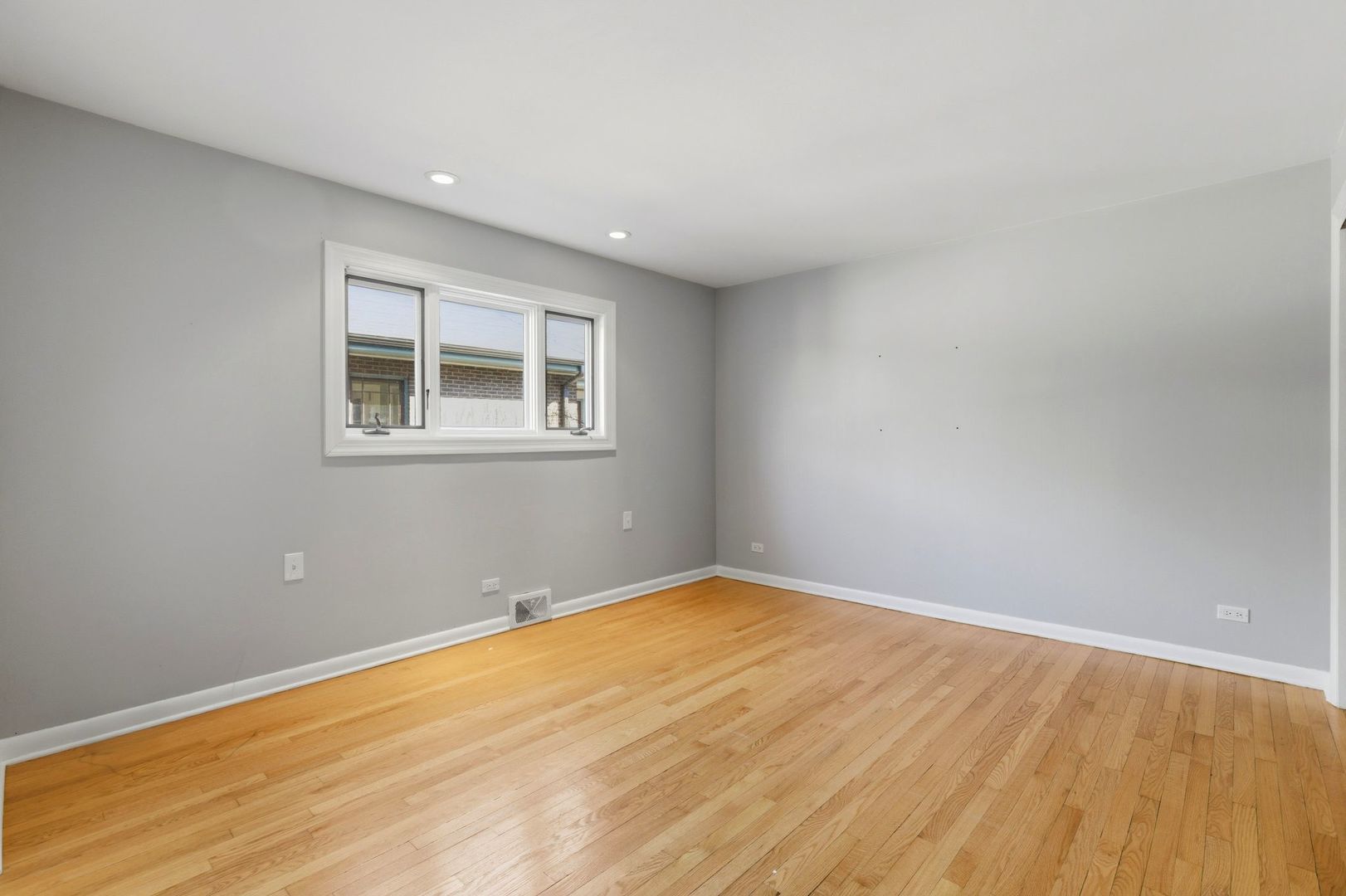 556 Barton Avenue, Unit 2 Evanston, IL 60202 - Photo 11 of 21 a view of empty room with wooden floor and fan