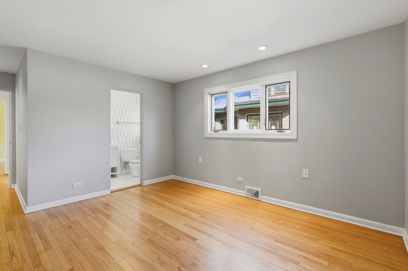556 Barton Avenue, Unit 2 Evanston, IL 60202 - Photo 12 of 21 a view of empty room with wooden floor and fan