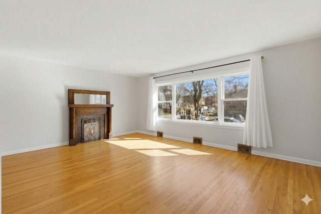556 Barton Avenue, Unit 2 Evanston, IL 60202 - Photo 2 of 21 a view of an empty room with a window and wooden floor