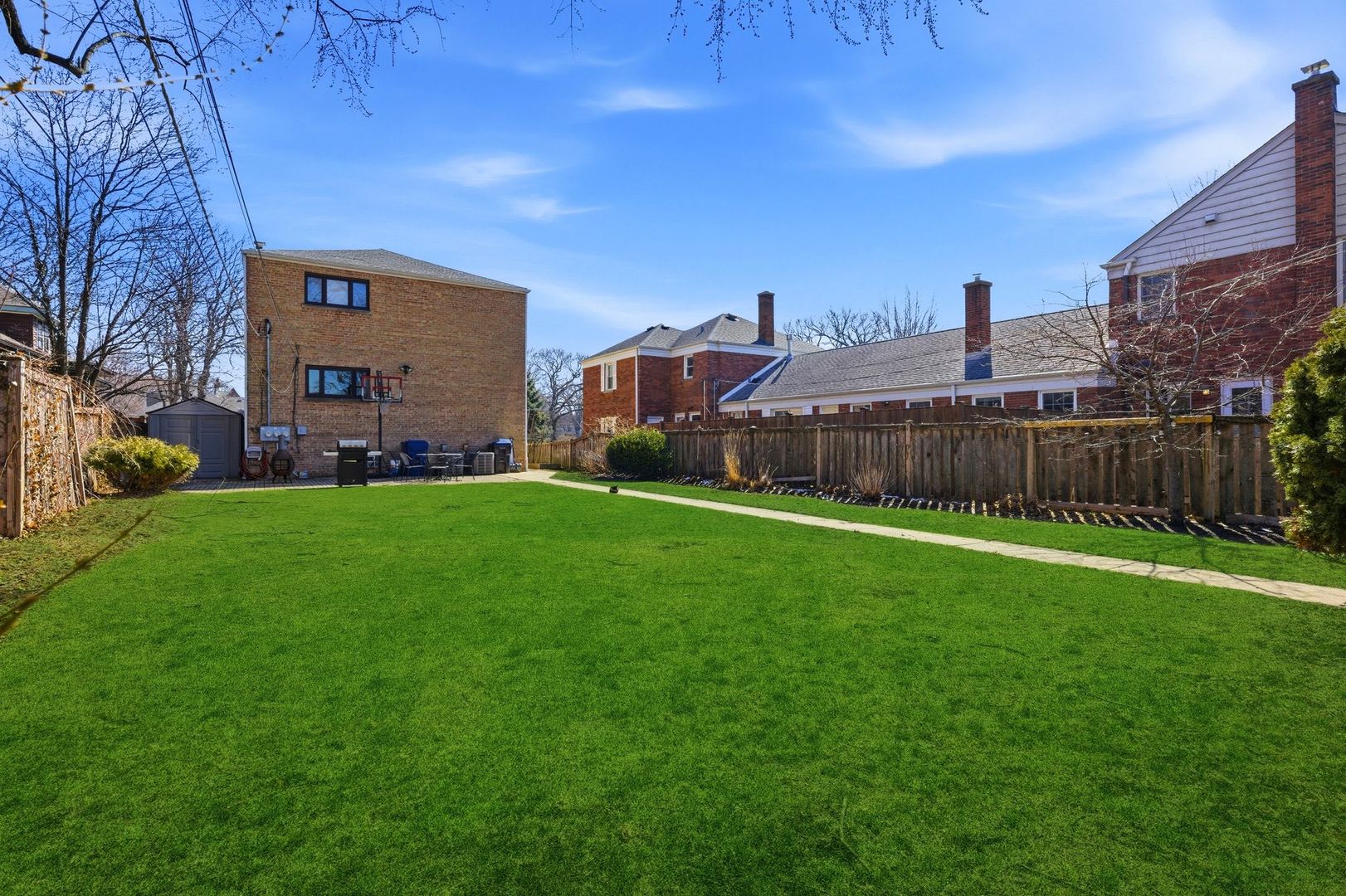 556 Barton Avenue, Unit 2 Evanston, IL 60202 - Photo 21 of 21 a view of a house with a big yard and large trees