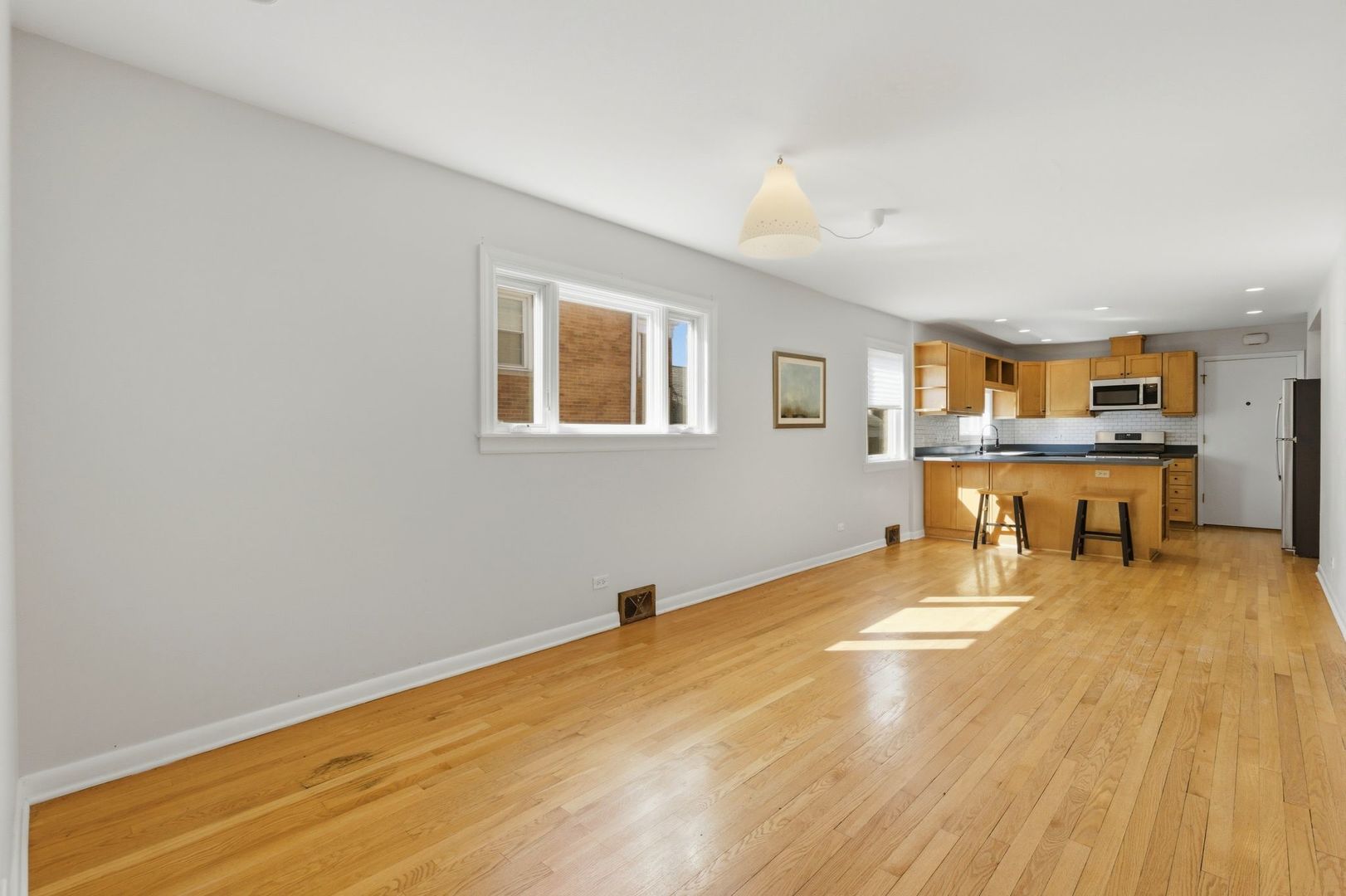 556 Barton Avenue, Unit 2 Evanston, IL 60202 - Photo 4 of 21 a living room with a table and chairs with wooden floor