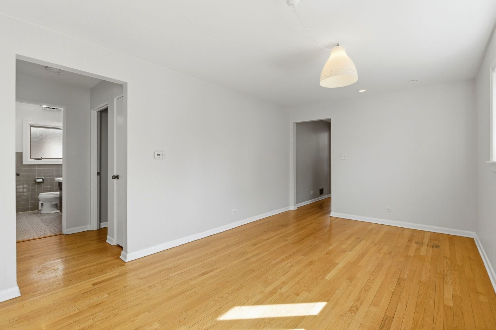 556 Barton Avenue, Unit 2 Evanston, IL 60202 - Photo 5 of 21 a view of an empty room and wooden floor