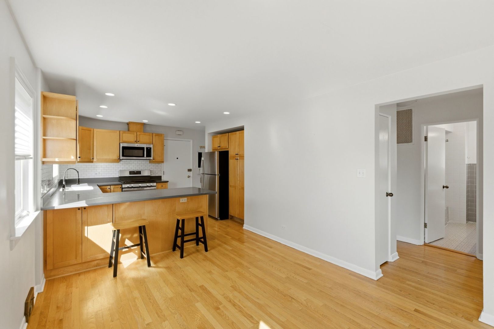 556 Barton Avenue, Unit 2 Evanston, IL 60202 - Photo 7 of 21 a kitchen with stainless steel appliances granite countertop a refrigerator and a stove top oven