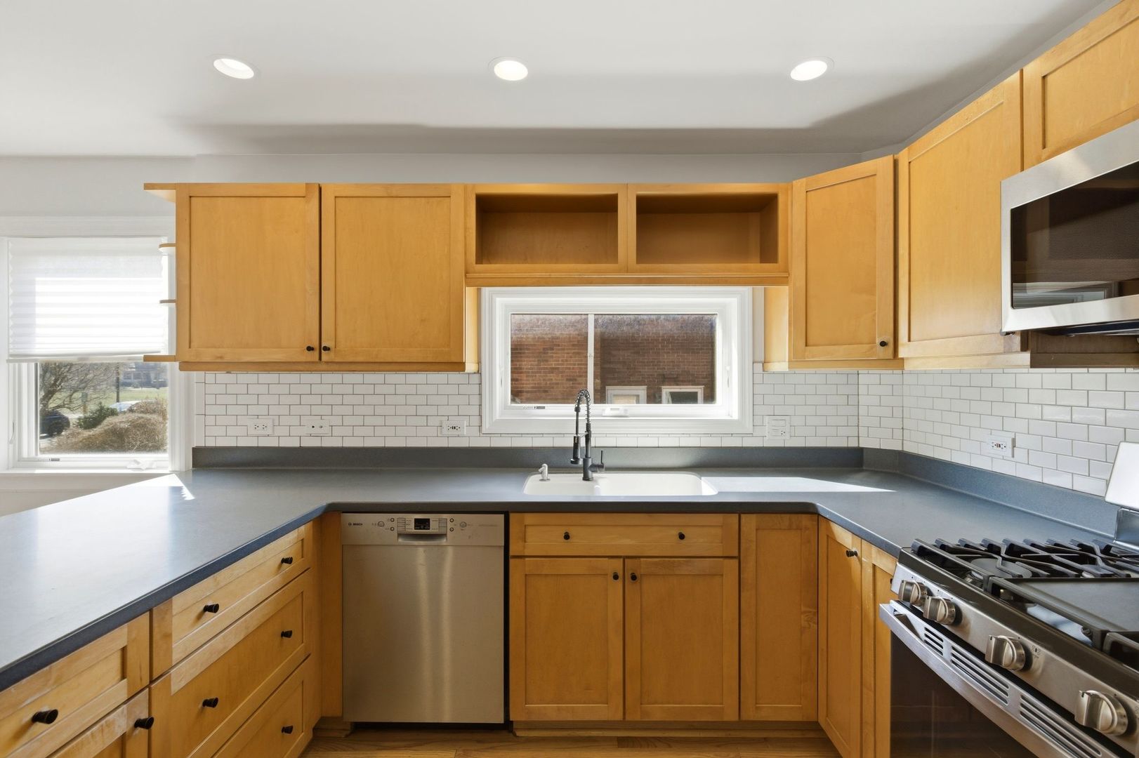 556 Barton Avenue, Unit 2 Evanston, IL 60202 - Photo 10 of 21 a kitchen with granite countertop a sink and a stove
