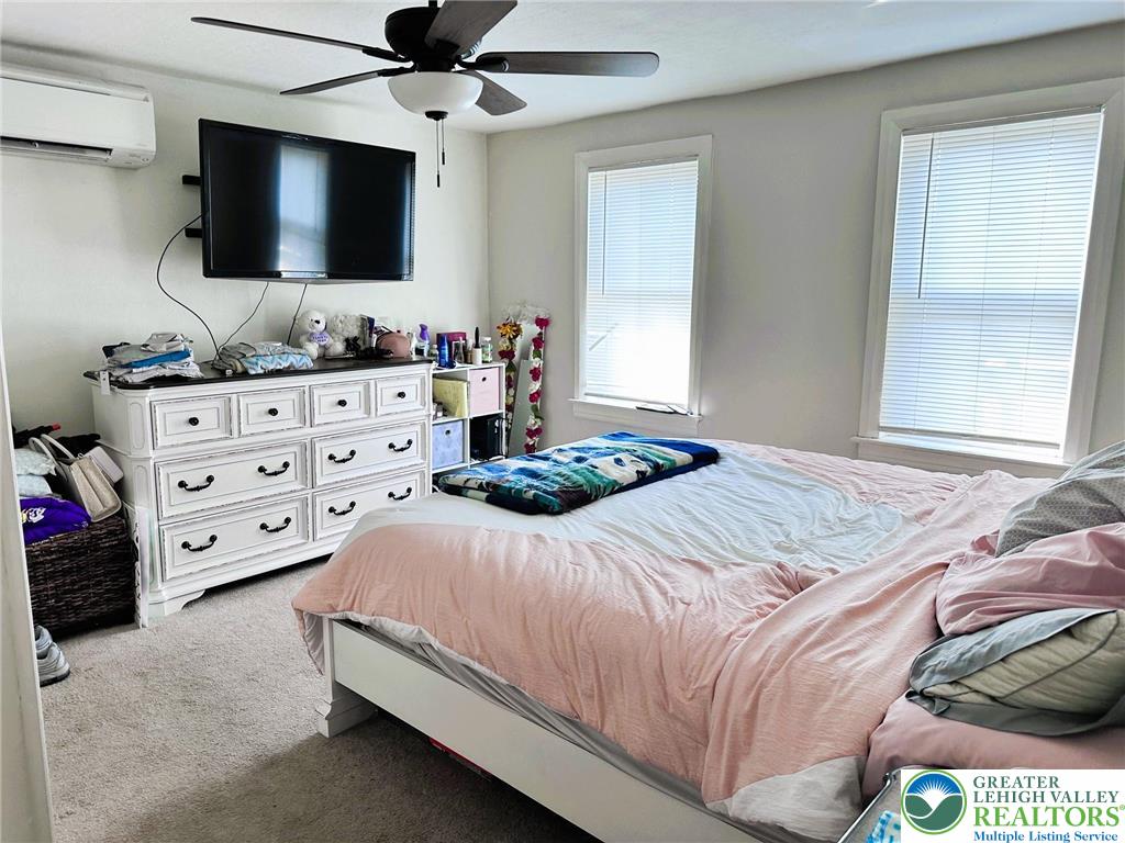 505 Penn Street Bath, PA 18014 - Photo 11 of 23 a bedroom with a bed and a flat tv screen on dresser