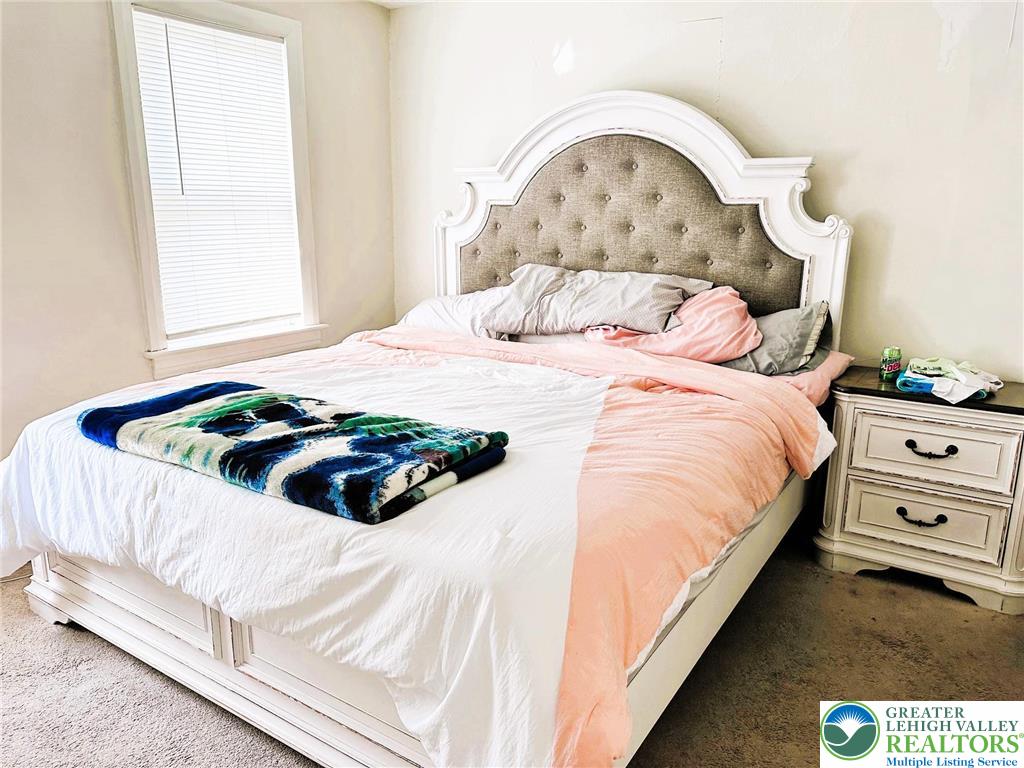 505 Penn Street Bath, PA 18014 - Photo 12 of 23 a bedroom with a bed and a painting on the wall