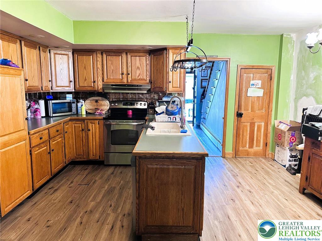 505 Penn Street Bath, PA 18014 - Photo 6 of 23 a kitchen with stainless steel appliances kitchen island granite countertop a stove a sink dishwasher and a refrigerator with wooden floor