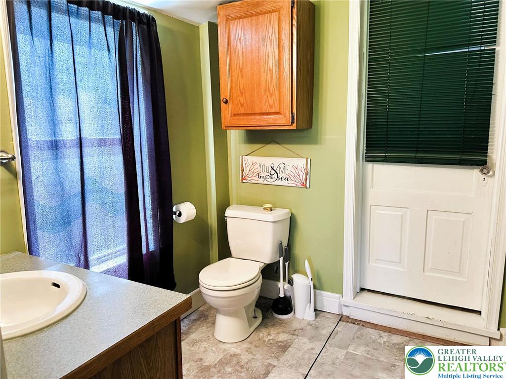 505 Penn Street Bath, PA 18014 - Photo 10 of 23 a bathroom with a toilet a sink and mirror