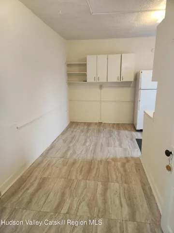 a view of wooden floor and cabinets in a room