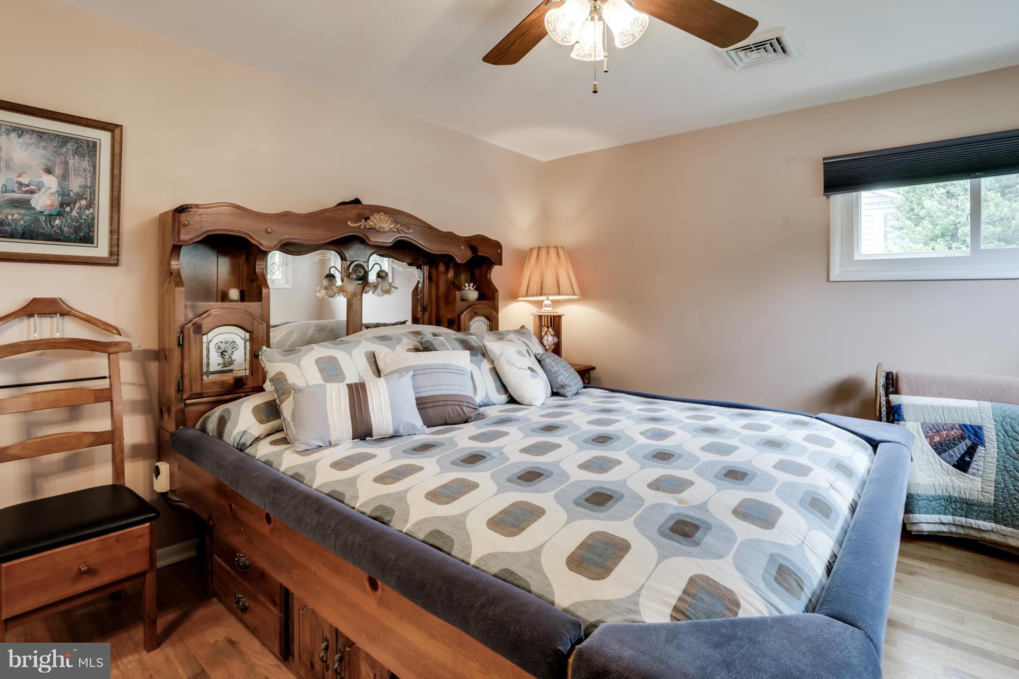 449 West Maple Road Linthicum Heights, MD 21090 - Photo 13 of 30 a bedroom with a bed and a chandelier