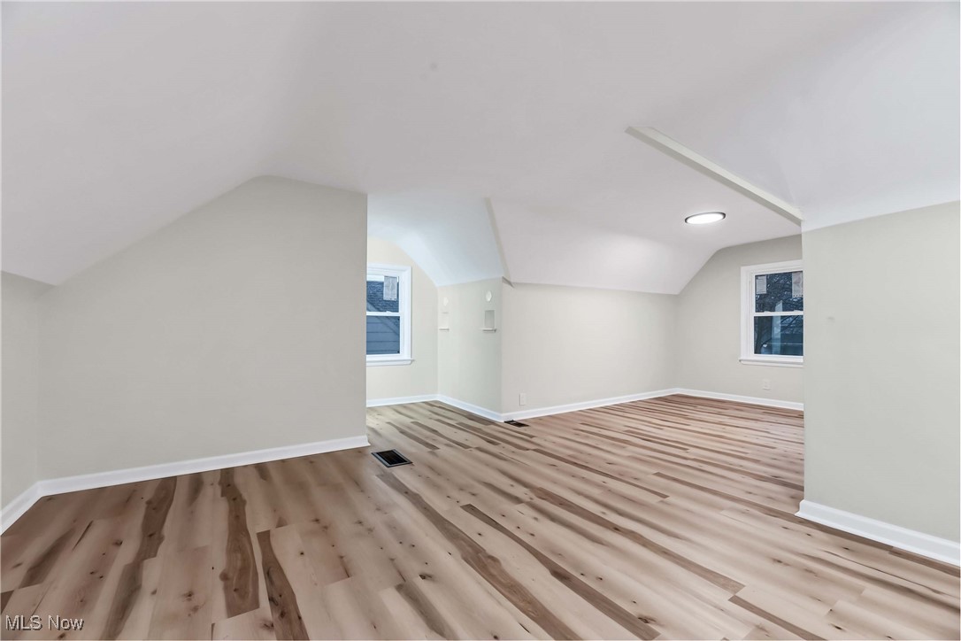 4209 Stilmore Road Cleveland, OH 44121 - Photo 24 of 36 Bonus room with baseboards, visible vents, and wood finished floors
