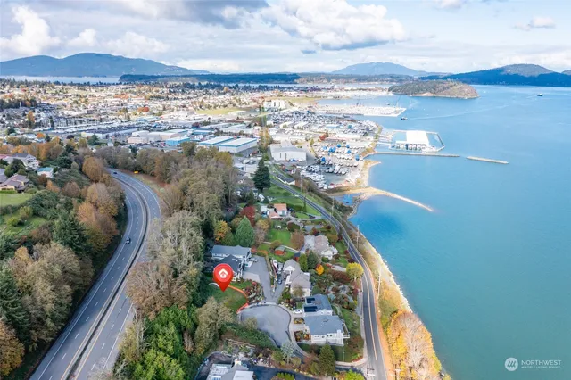 a view of a lake in front of house with outdoor seating