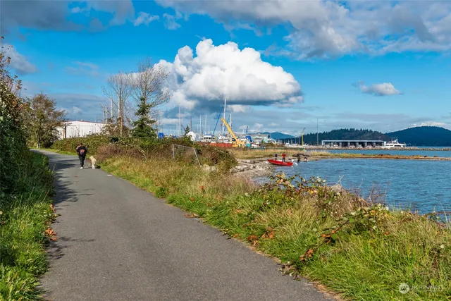 an aerial view of a swimming pool with outdoor seating and lake