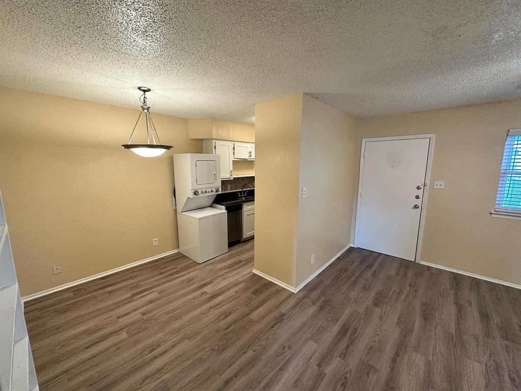 2401 Manor Road, Unit 220 Austin, TX 78722 - Photo 10 of 17 Laminate wood flooring flows seamlessly through the open dining and living areas.