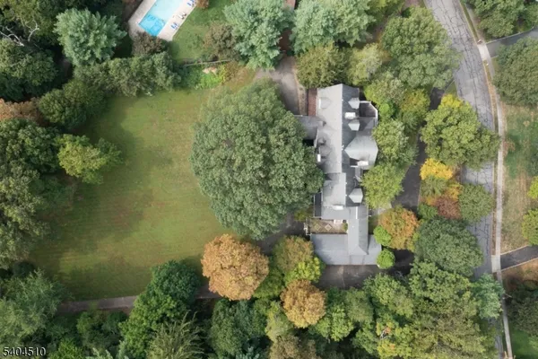 an aerial view of a house with a yard and lake view