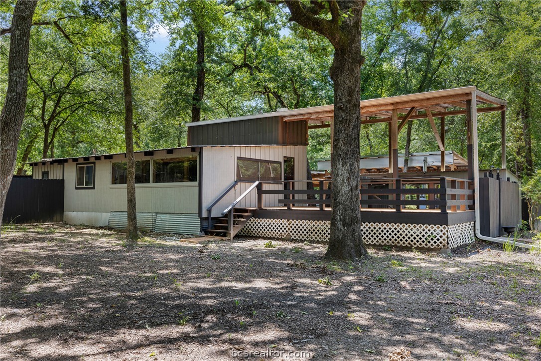 12255 County Road Centerville, TX 75833 - Photo 2 of 26 a view of a house with a floor to ceiling window and a large tree