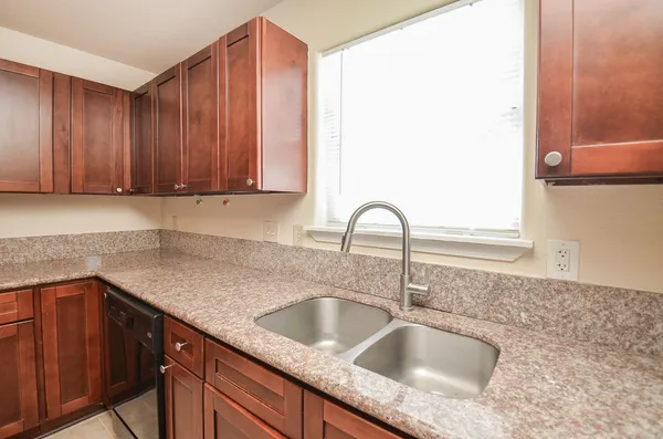 a kitchen with stainless steel appliances granite countertop a stove a sink dishwasher a refrigerator and a microwave
