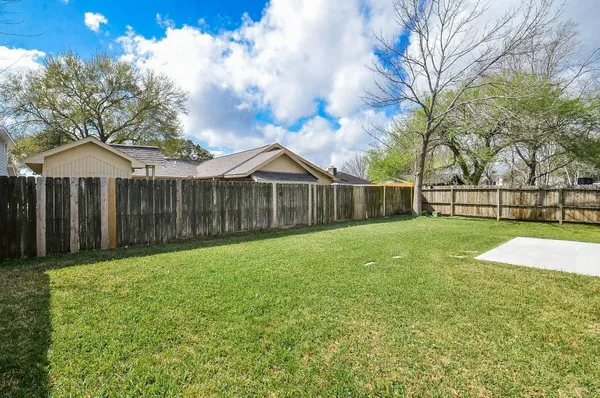 a front view of a house with a garden and yard