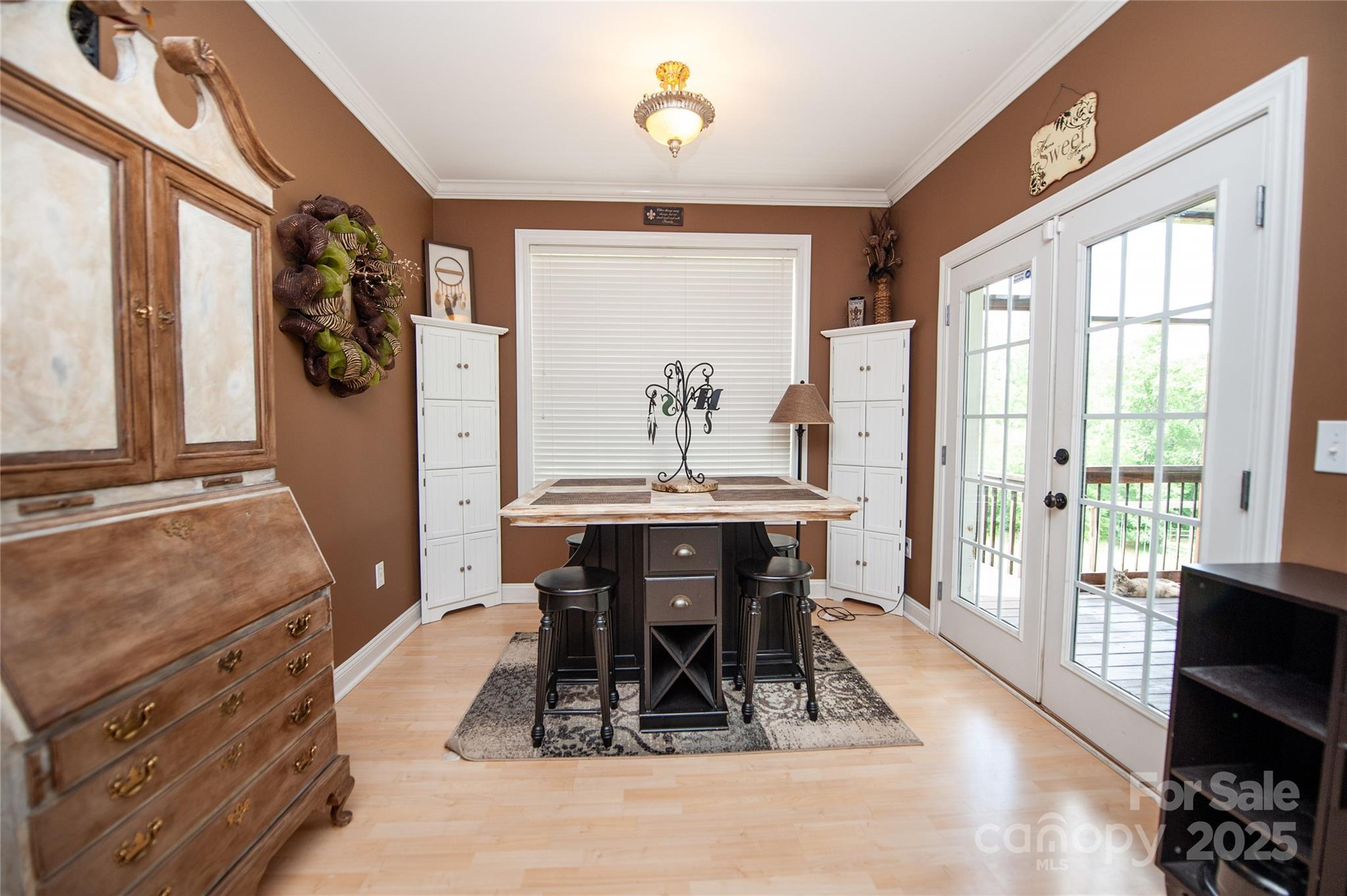 2650 Rainbow Lake Road Inman, SC 29349 - Photo 20 of 48 a dining room with wooden floor a chandelier a wooden table and chairs